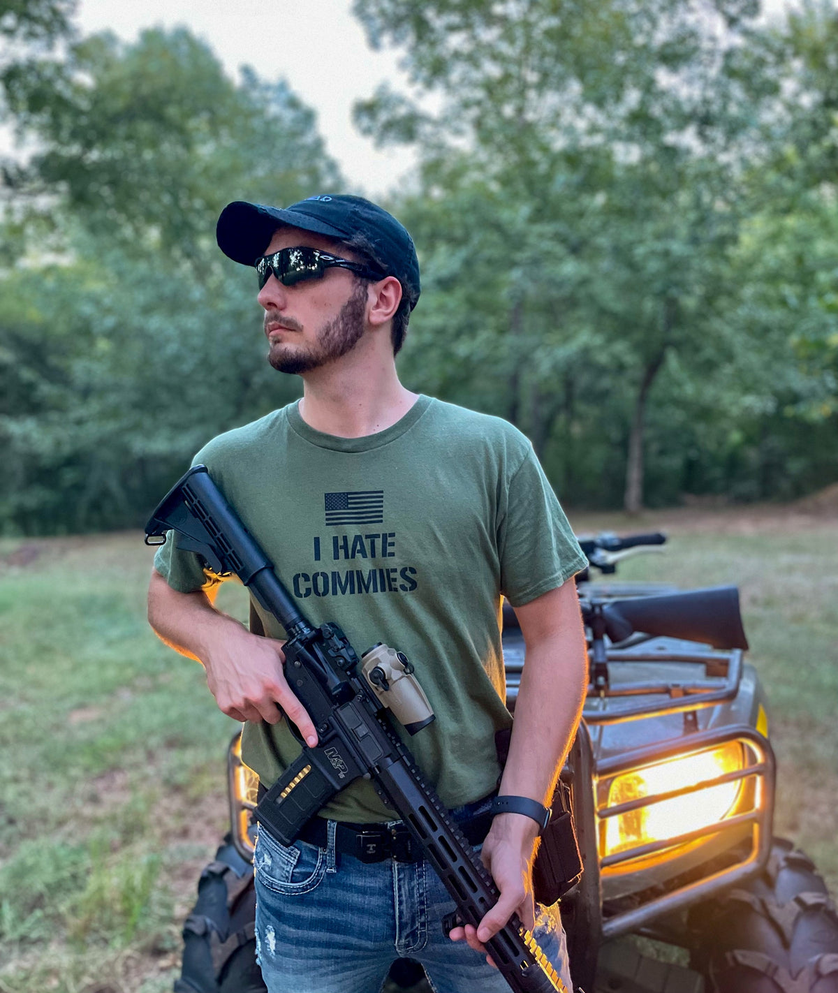 I Hate Commies T-Shirt worn at night with a rifle, Triad cap